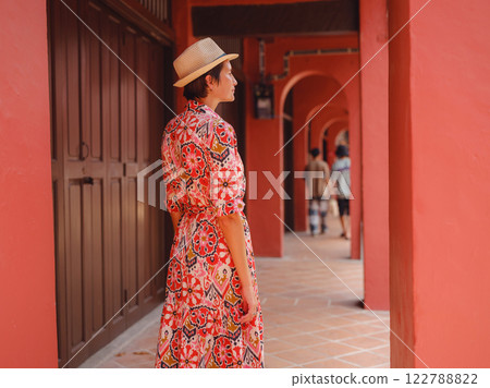 woman in dress and hat exploring vibrant streets of Malacca, Malaysia. woman in dress and hat exploring vibrant streets of Malacca, Malaysia. 122788822