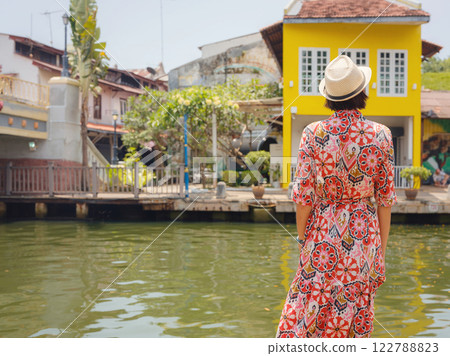 woman in dress and hat exploring vibrant streets of Malacca, Malaysia. woman in dress and hat exploring vibrant streets of Malacca, Malaysia. 122788823