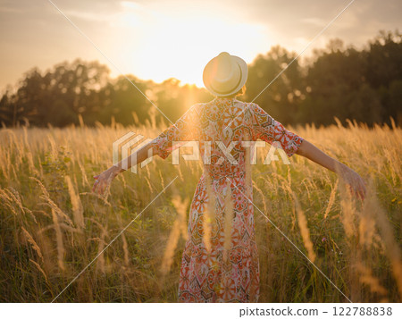 boho chic woman in a floral dress in European countryside 122788838