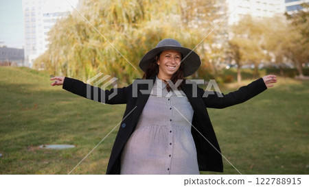 Portrait of a beautiful happy woman in spring in a city park Portrait of a beautiful happy woman in spring in a city park 122788915