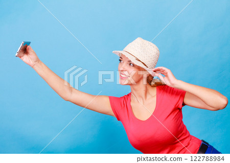 Tourist blonde woman taking pictures with phone Tourist blonde woman taking pictures with phone 122788984