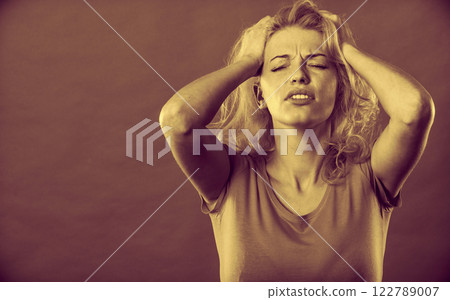 Stressed, frustrated, depressed young woman in pain Stressed, frustrated, depressed young woman in pain 122789007