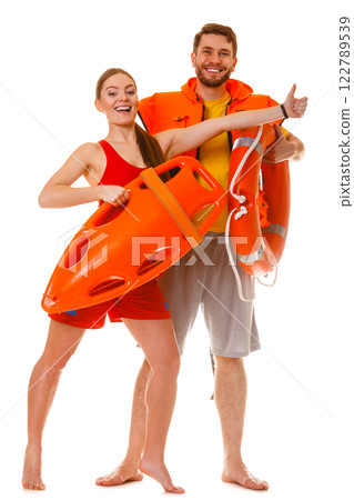 Lifeguards with rescue ring buoy and life vest. Lifeguards with rescue ring buoy and life vest. 122789539