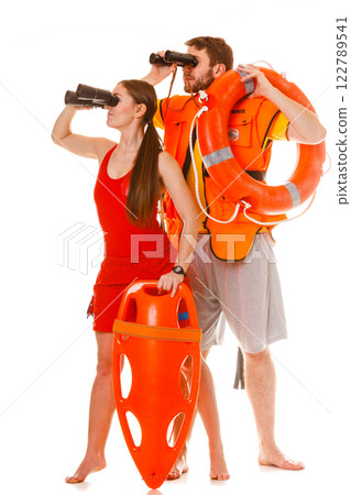 Lifeguards with rescue ring buoy and life vest. 122789541
