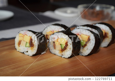 Homemade sushi roll on wood board. Japanese food. 122789711