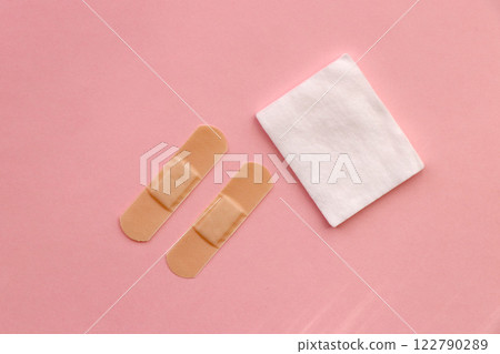 Bandage and cotton wool (pink background) Bandage and cotton wool (pink background) 122790289