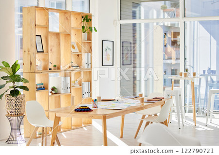 Empty interior office with light, wood furniture and workplace space for business and work. Modern and minimalist design decoration of a corporate or creative room for working employee or staff Empty interior office with light, wood furniture and workplace space for business and work. Modern and minimalist design decoration of a corporate or creative room for working employee or staff 122790721