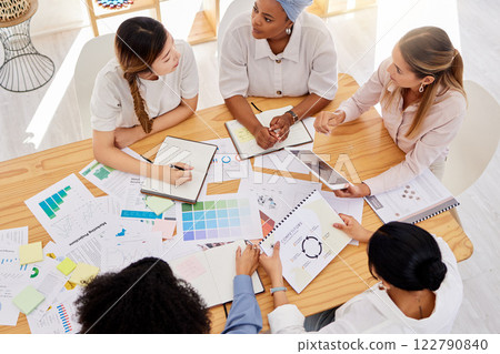 Creative team planning a project with digital tablet and paperwork in corporate office. Top view of professional employees writing notes and analyzing documents with graphs, charts and color wheels. Creative team planning a project with digital tablet and paperwork in corporate office. Top view of professional employees writing notes and analyzing documents with graphs, charts and color wheels. 122790840