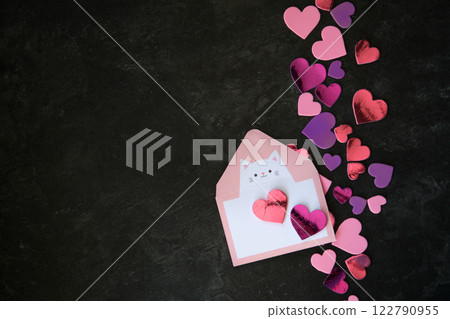 multicolored hearts on dark background and envelope 122790955