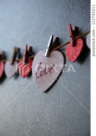 On the heart there is an inscription love next to other hearts On the heart there is an inscription love next to other hearts 122791011
