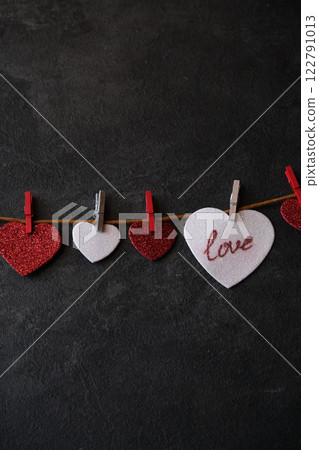 On the heart there is an inscription love next to other hearts On the heart there is an inscription love next to other hearts 122791013