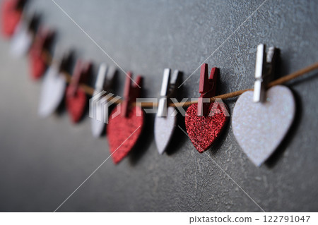 On a dark background on a string of hearts On a dark background on a string of hearts 122791047
