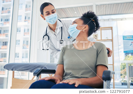 Nurse helping covid patient in a wheelchair after medical treatment in a hospital room. Healthcare employee helping a disabled person in the clinic ward. Doctor consulting woman with coronavirus. Nurse helping covid patient in a wheelchair after medical treatment in a hospital room. Healthcare employee helping a disabled person in the clinic ward. Doctor consulting woman with coronavirus. 122791077