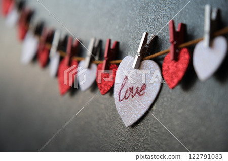 On the heart there is an inscription love next to other hearts On the heart there is an inscription love next to other hearts 122791083