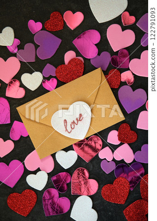 multicolored hearts on dark background and envelope 122791093