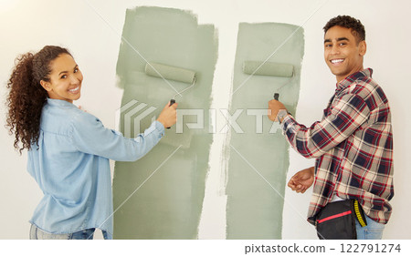 Portrait of happy couple painting room or interior house renovation and home or property design project with smile, white wall background. New home or apartment and happy painter people and DIY paint Portrait of happy couple painting room or interior house renovation and home or property design project with smile, white wall background. New home or apartment and happy painter people and DIY paint 122791274