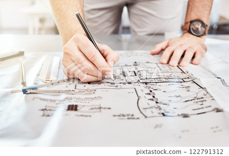 Drawing construction on blueprint, planning architecture design on paper and writing notes on building documents on table in work office. Designer, architect and builder with strategy for renovation Drawing construction on blueprint, planning architecture design on paper and writing notes on building documents on table in work office. Designer, architect and builder with strategy for renovation 122791312