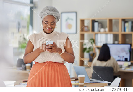 Business woman typing on social media on phone at work, reading email and networking with people online on a smartphone in an office. Happy black woman in communication on internet with technology 122791414