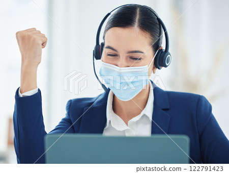Call center worker in celebration of work success, giving support to person in online communication and happy about win in telemarketing industry. Woman with covid face mask cheeering with laptop 122791423