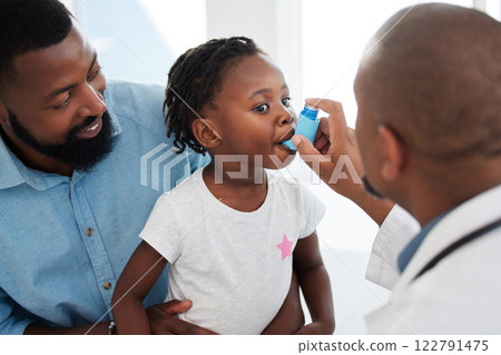 Doctor helping a child patient with an asthma inhaler in his office at the medical clinic. Healthcare worker consulting a girl with chest or respiratory problems with pump in a childrens hospital Doctor helping a child patient with an asthma inhaler in his office at the medical clinic. Healthcare worker consulting a girl with chest or respiratory problems with pump in a childrens hospital 122791475
