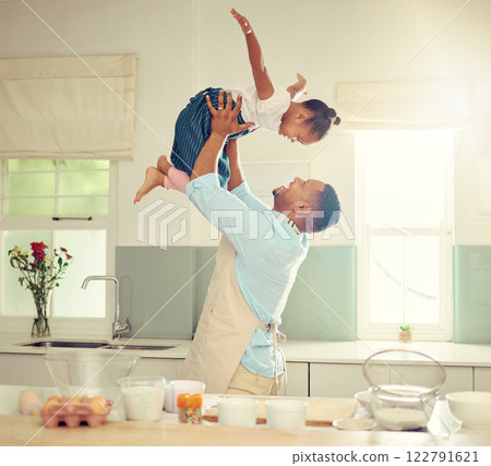 Happy black father and daughter playing in a kitchen while cooking together, bonding and laughing. African American parent enjoying family time with his child, playful and having fun while baking Happy black father and daughter playing in a kitchen while cooking together, bonding and laughing. African American parent enjoying family time with his child, playful and having fun while baking 122791621