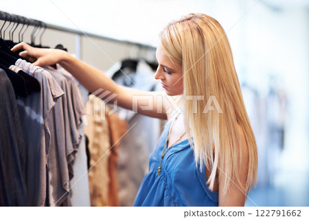 Woman, shopping and fashion boutique at designer clothing retail business in lifestyle mall. Stylish caucasian customer in apparel store with fashionable clothes choice on rack at shop. Woman, shopping and fashion boutique at designer clothing retail business in lifestyle mall. Stylish caucasian customer in apparel store with fashionable clothes choice on rack at shop. 122791662