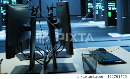 Computers in server farm used to ensure optimal performance and reliability, managing supercomputers. High tech data center used for overseeing network connections, handheld camera shot Computers in server farm used to ensure optimal performance and reliability, managing supercomputers. High tech data center used for overseeing network connections, handheld camera shot 122791733