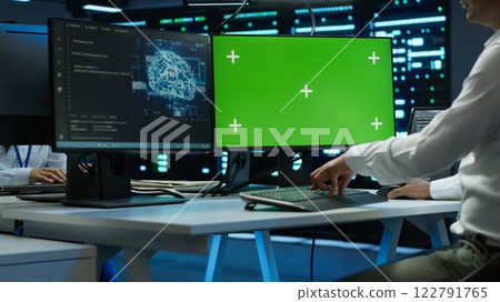 Engineer using AI tech on green screen PC to do checkup in server room. Zoom in of expert in data center using artificial intelligence on mockup computer to process datasets for training, camera A 122791765