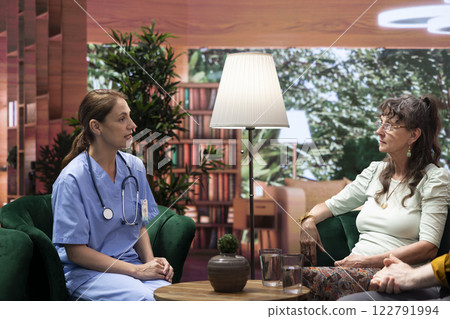 Nurse specialist provides home care for an elderly couple showing her support for their recovery. Senior living assistance and health aid for a comforting and professional social visit. Nurse specialist provides home care for an elderly couple showing her support for their recovery. Senior living assistance and health aid for a comforting and professional social visit. 122791994