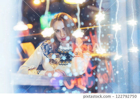 Young beautiful woman sitting in cafe, drinking wine. Christmas, new year, Valentines day, winter holidays concept Young beautiful woman sitting in cafe, drinking wine. Christmas, new year, Valentines day, winter holidays concept 122792750