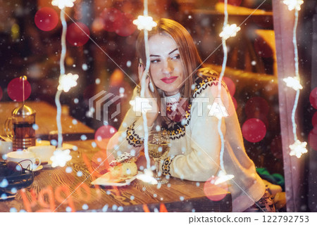 Young beautiful woman sitting in cafe, drinking wine. Christmas, new year, Valentines day, winter holidays concept Young beautiful woman sitting in cafe, drinking wine. Christmas, new year, Valentines day, winter holidays concept 122792753