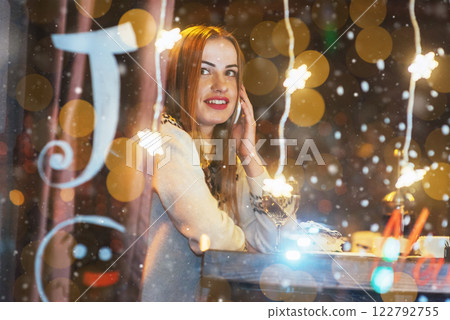Young beautiful woman sitting in cafe, drinking wine. Christmas, new year, Valentines day, winter holidays concept 122792755