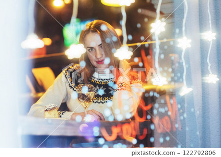 Young beautiful woman sitting in cafe, drinking wine. Christmas, new year, Valentines day, winter holidays concept Young beautiful woman sitting in cafe, drinking wine. Christmas, new year, Valentines day, winter holidays concept 122792806