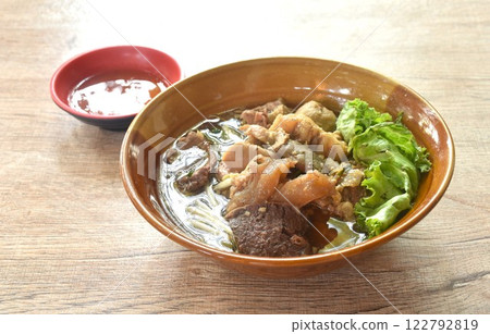 boiled braised beef meat and tendon couple organ in herb brown soup on bowl dipping spicy chili sauce boiled braised beef meat and tendon couple organ in herb brown soup on bowl dipping spicy chili sauce 122792819