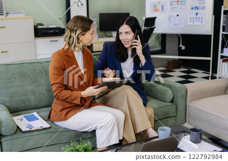 Diverse professionals collaborate on project data analysis, and teamwork in modern office. 122792984