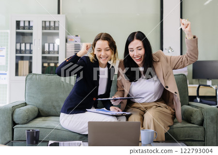 Business team creative are excited business success with inspiration from their excellent financial results that are happy working in a modern office on a computer. 122793004