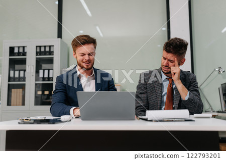 International business people, teamwork, people and crisis concept - business team sitting stress and worried problems from working in the office. International business people, teamwork, people and crisis concept - business team sitting stress and worried problems from working in the office. 122793201