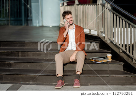 Businessman Talking on Mobile Phone in City. 122793291