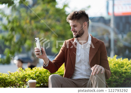 Happy Businessman Relaxing in the City, Engaging in Digital Social Media. 122793292