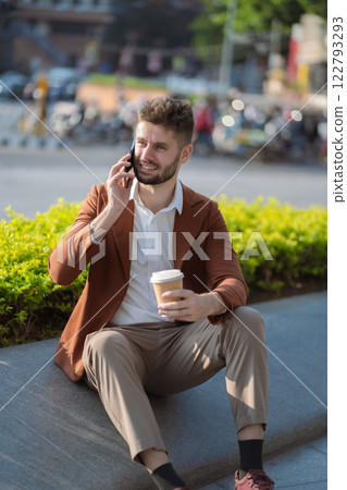 Businessman Talking on Mobile Phone in City. 122793293