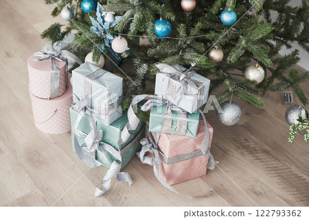 Christmas tree with wooden rustic decorations and presents under it in loft interior Christmas tree with wooden rustic decorations and presents under it in loft interior 122793362