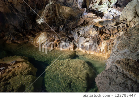 Clear water flowing through the limestone cave Clear water flowing through the limestone cave 122793447