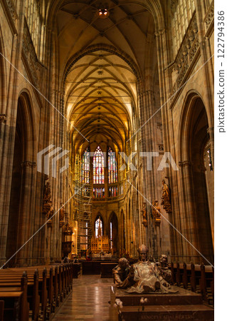 Interior of Gothic Cathedral inside. Carved pulpit, stained-glass Windows through which light rays penetrate building Prague, Czech Republic 122794386