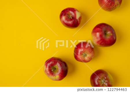Flat lay composition with many red apples on yellow background. Space for text Flat lay composition with many red apples on yellow background. Space for text 122794463
