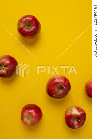 Flat lay composition with many red apples on yellow background. Space for text Flat lay composition with many red apples on yellow background. Space for text 122794464