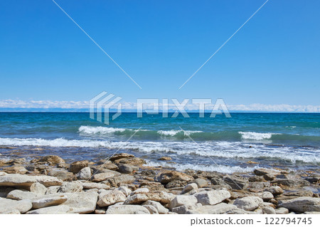 Issyk-Kul lake, stone coast. Summer natural landscape, vacation in Kyrgyzstan 122794745