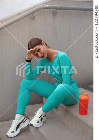 Fitness Girl On Stairs Has Rest. Fit Woman On Break From Exercising. Female In Fashion Sporty Outfit Doing Interval Cardio Workout Outdoor In City. Fitness Girl On Stairs Has Rest. Fit Woman On Break From Exercising. Female In Fashion Sporty Outfit Doing Interval Cardio Workout Outdoor In City. 122794980
