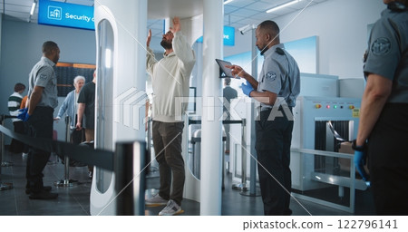 Passengers Passing Through Metal Detector Scanner. Airport Staff Control People TSA Screening Procedure 122796141
