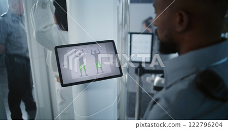 Security System Airport: Security Officer Controls Human Body Scanning Using Tablet Computer 122796204