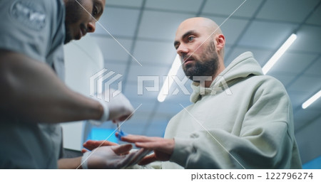 Security Officer Conducts TSA Hand Swab Screening with Brush to Adult Man for Boarding Flight Security Officer Conducts TSA Hand Swab Screening with Brush to Adult Man for Boarding Flight 122796274